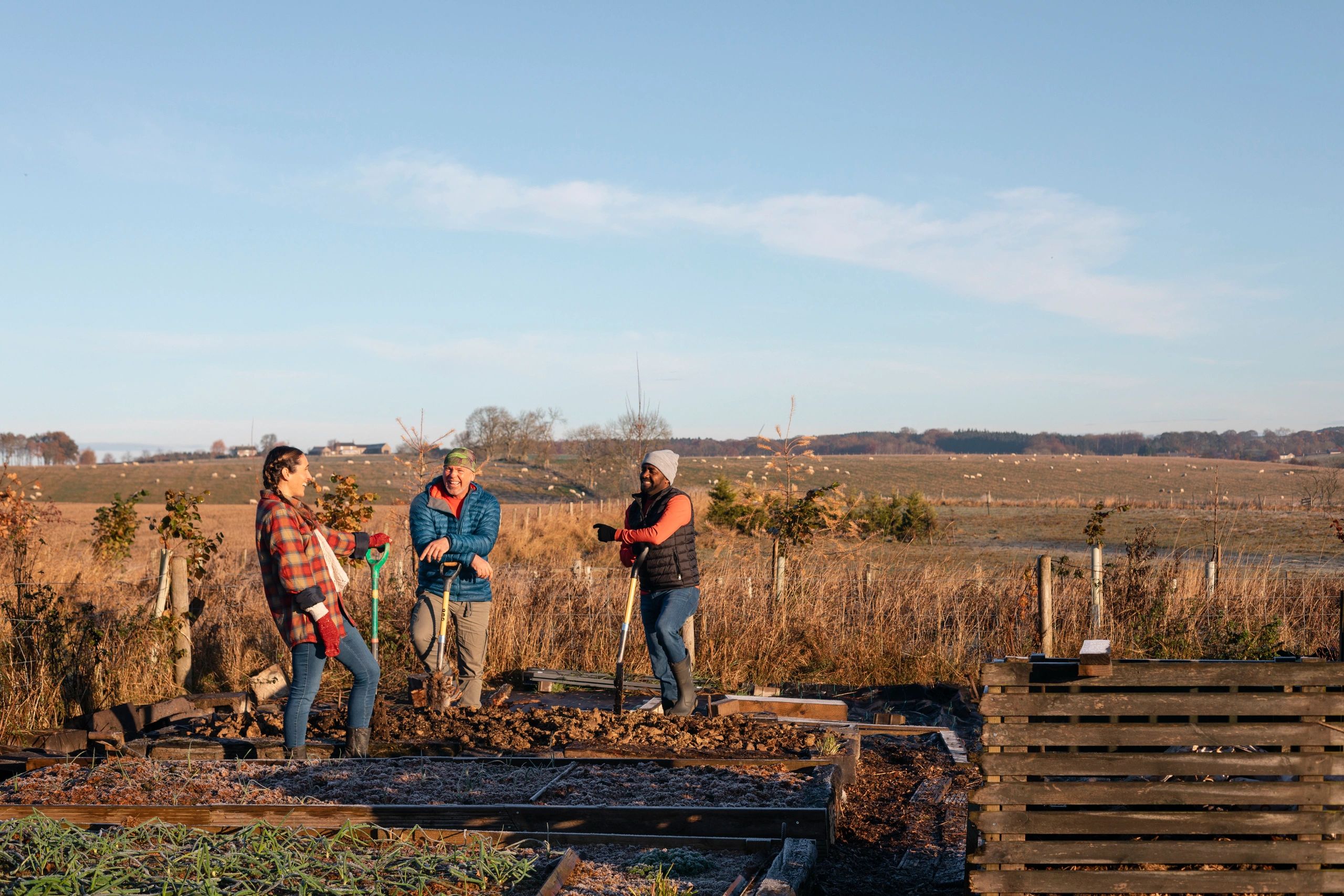 Community volunteers talking while working on a sustainable farm project